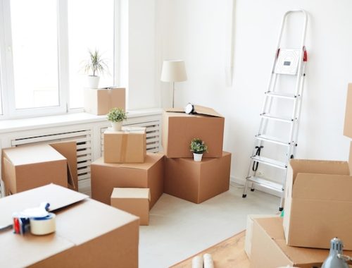 stacked-cardboard-boxes-empty-white-room-moving-relocation-house-decor-concept_236854-22627